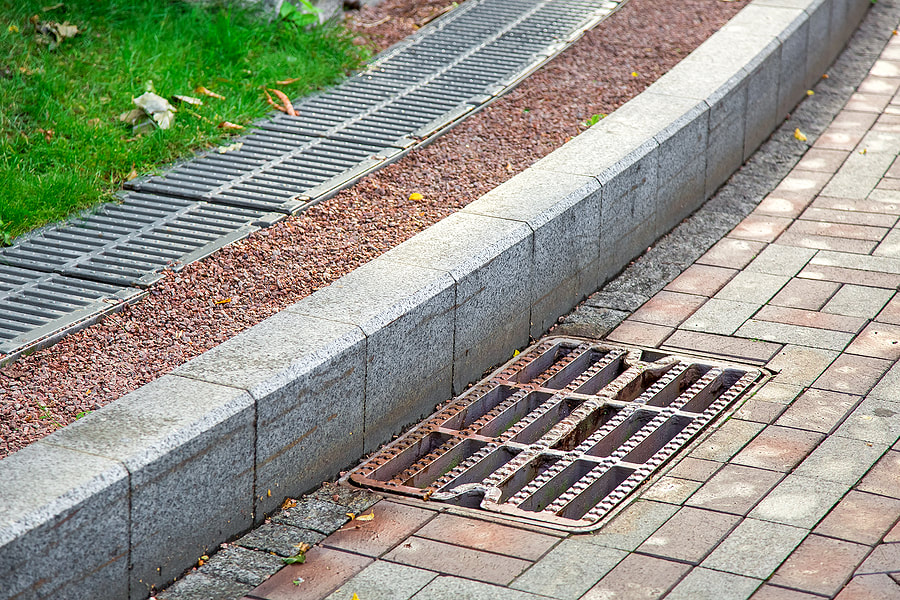 a sidewalk metal drainage